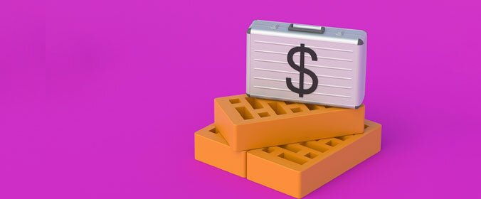 imagem de uma maleta de dinheiro sobre blocos de construção