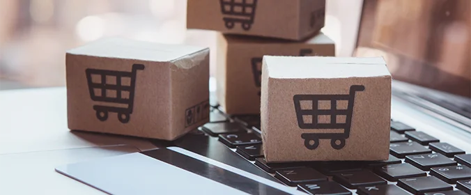 foto de pequenas caixas com desenho de carrinhos de supermercados, sobre um notebook