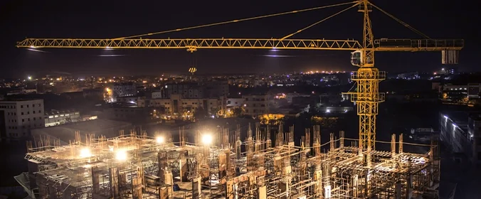 foto de um canteiro de obras visto de noite e completamente ilumindado