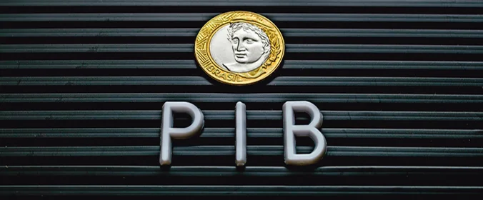foto de um letreito com a sigla PIB e uma moeda de um real em cima    