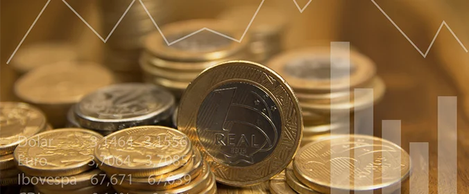 foto de uma moeda de um real brasileiro e o desenho de gráficos em cima